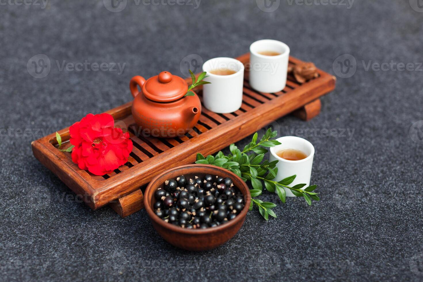 Traditional Chinese tea ceremony with black currant, fruit tea and healthy food. Photo without people. Summer natural vitamins and berries