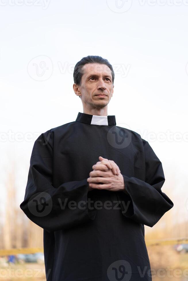 Portrait of handsome catholic priest or pastor with collar photo