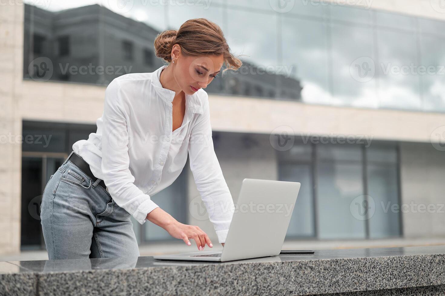 Businesswoman successful woman business person outdoor corporate building exterior. Pensive caucasian confidence professional business woman middle age photo