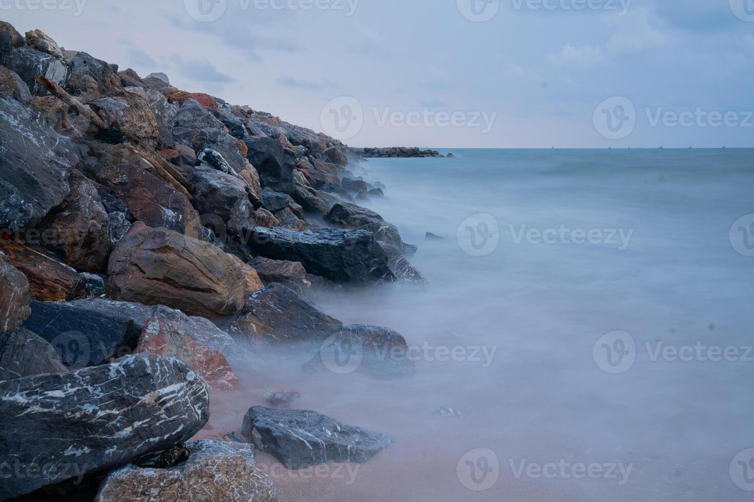 Rock breakwater in the sea in the morning photo