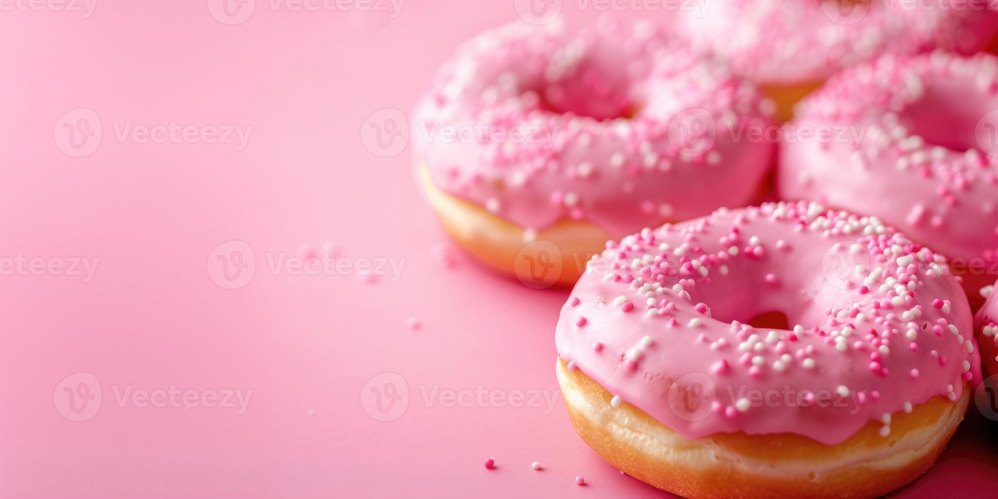 AI generated Donuts in pink glaze on a light pink background with copy space photo
