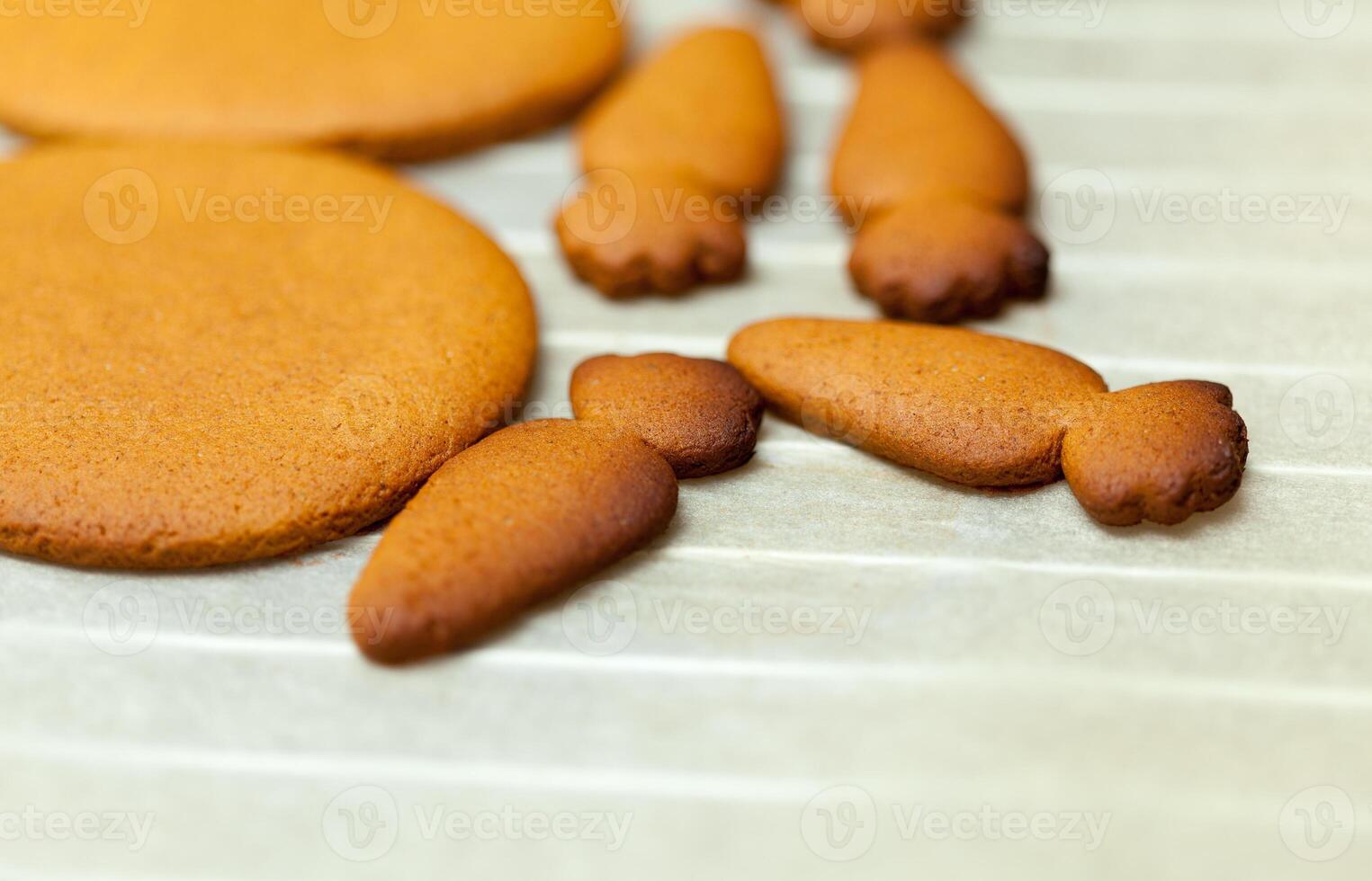 close up of female hands making cookies from fresh dough at home photo