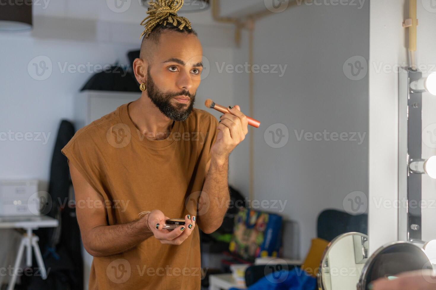 Gay applying make up on face photo