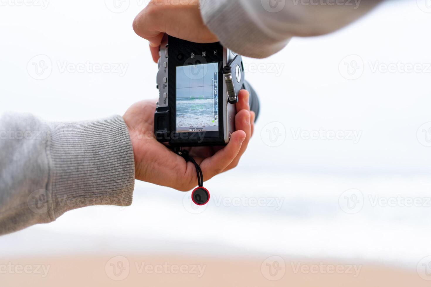 Traveller make photo holding mirrorless camera in hand