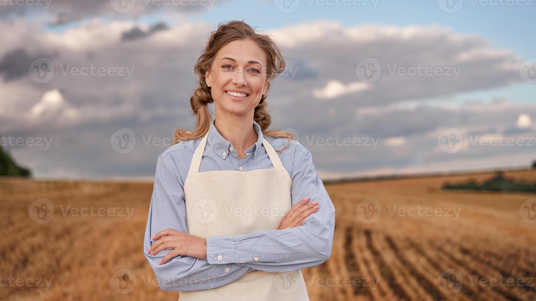 Woman farmer apron standing farmland smiling Female agronomist specialist farming agribusiness Happy positive caucasian worker agricultural field photo