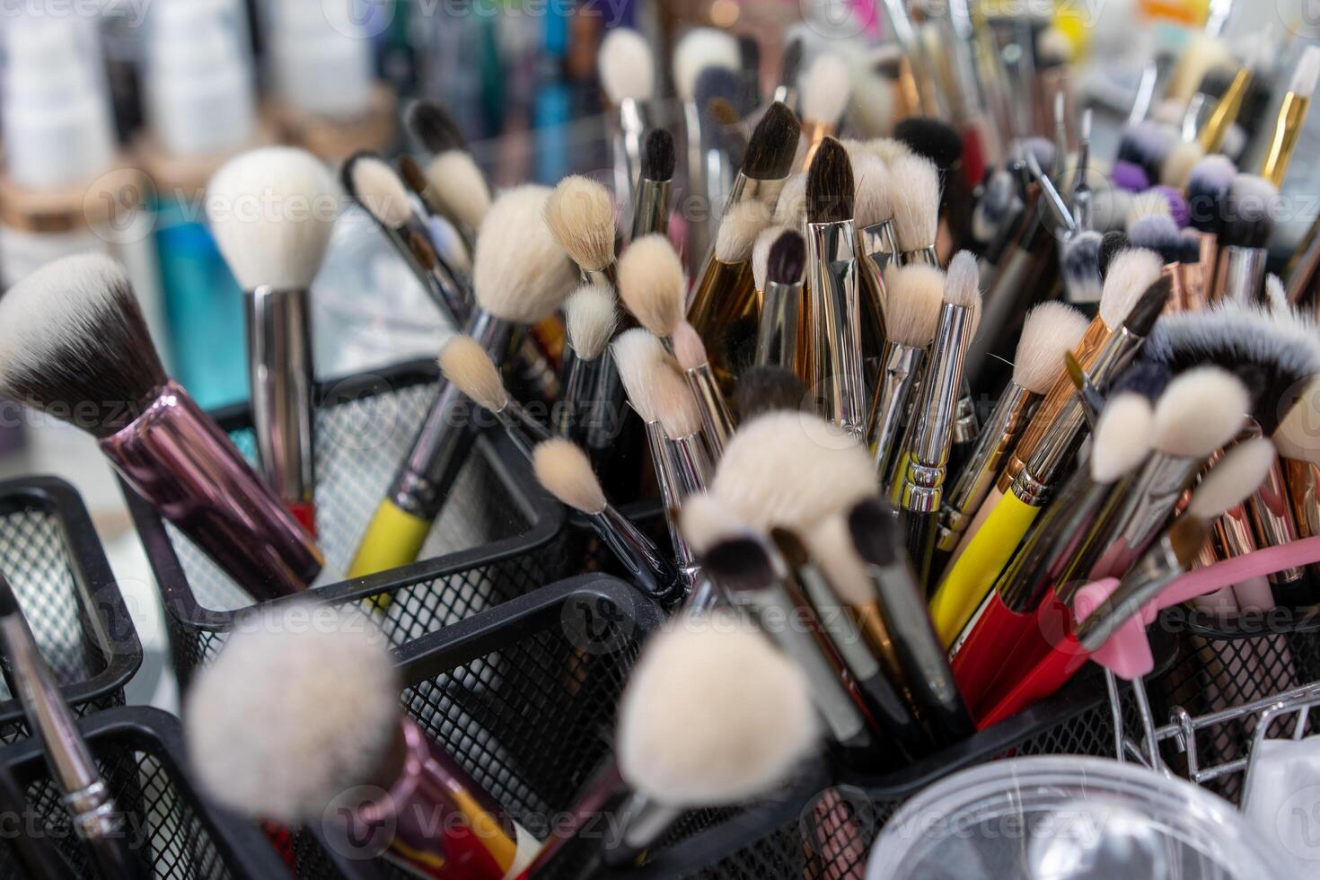 Makeup brushes there A lot of brushes randomly standing in containers at the workplace of a makeup artist or stylist. photo