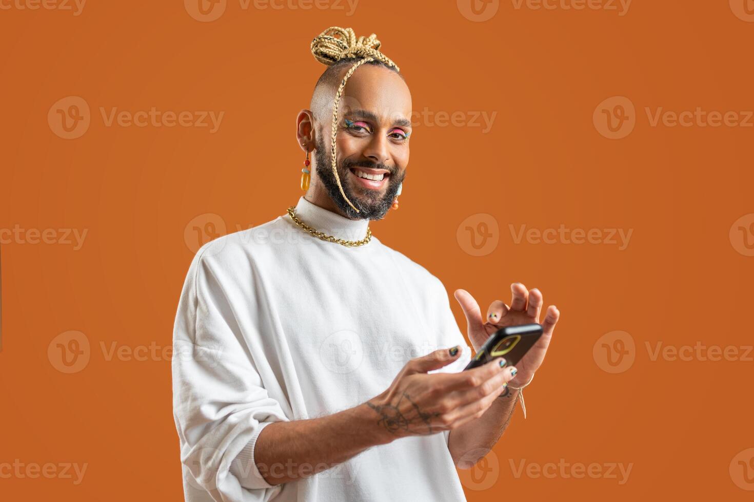 Black Gay Man with bright makeup use smartphone photo