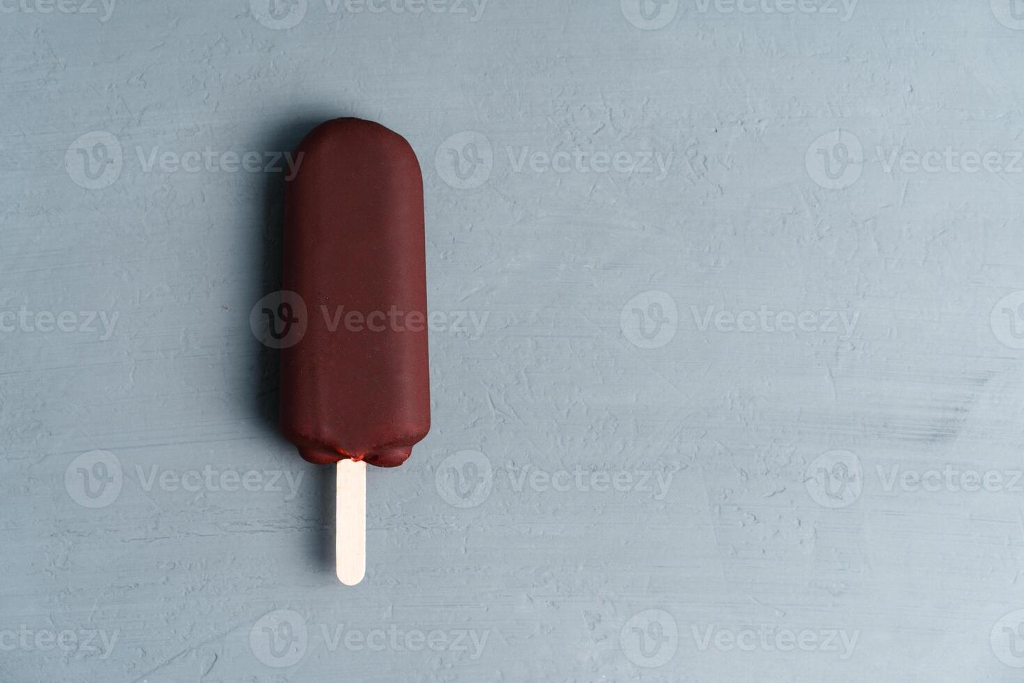 ice cream stick  on dark  background  covered chocolate sticks frozen Popsicle and Lolly sweet dessert  Flat lay photo