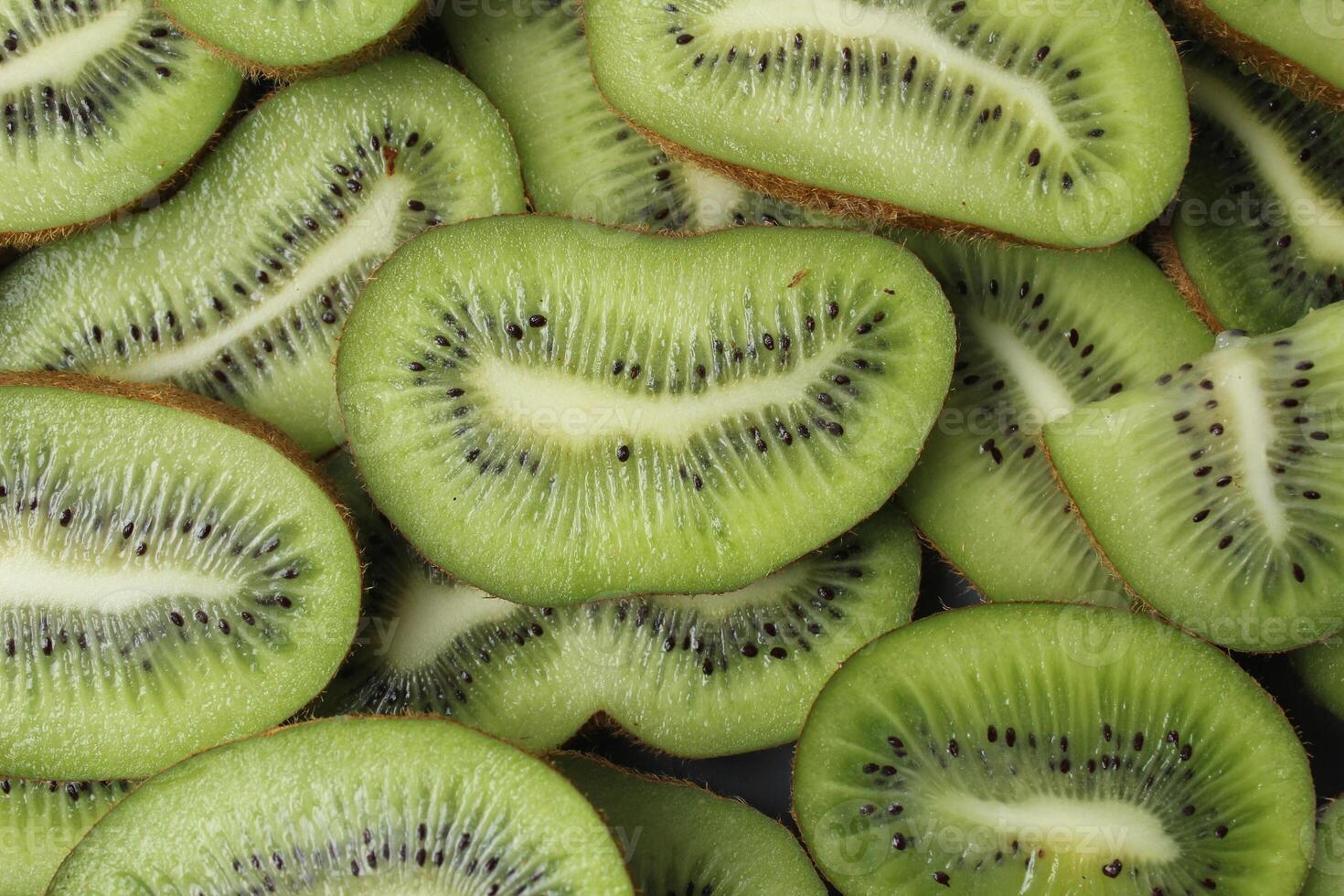 Close-up of kiwi fruit background with space for copy space text. Kiwi slices with a beautiful slit photo