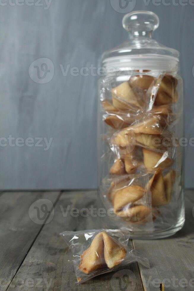 Chinese cookies in a jar and on a table on a gray background with space for text. Fortune Telling photo