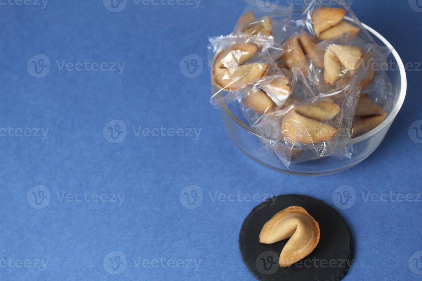 Fortune cookies in a jar bowl on the background of copyspace. Prediction text in cookies. Holiday Traditions photo