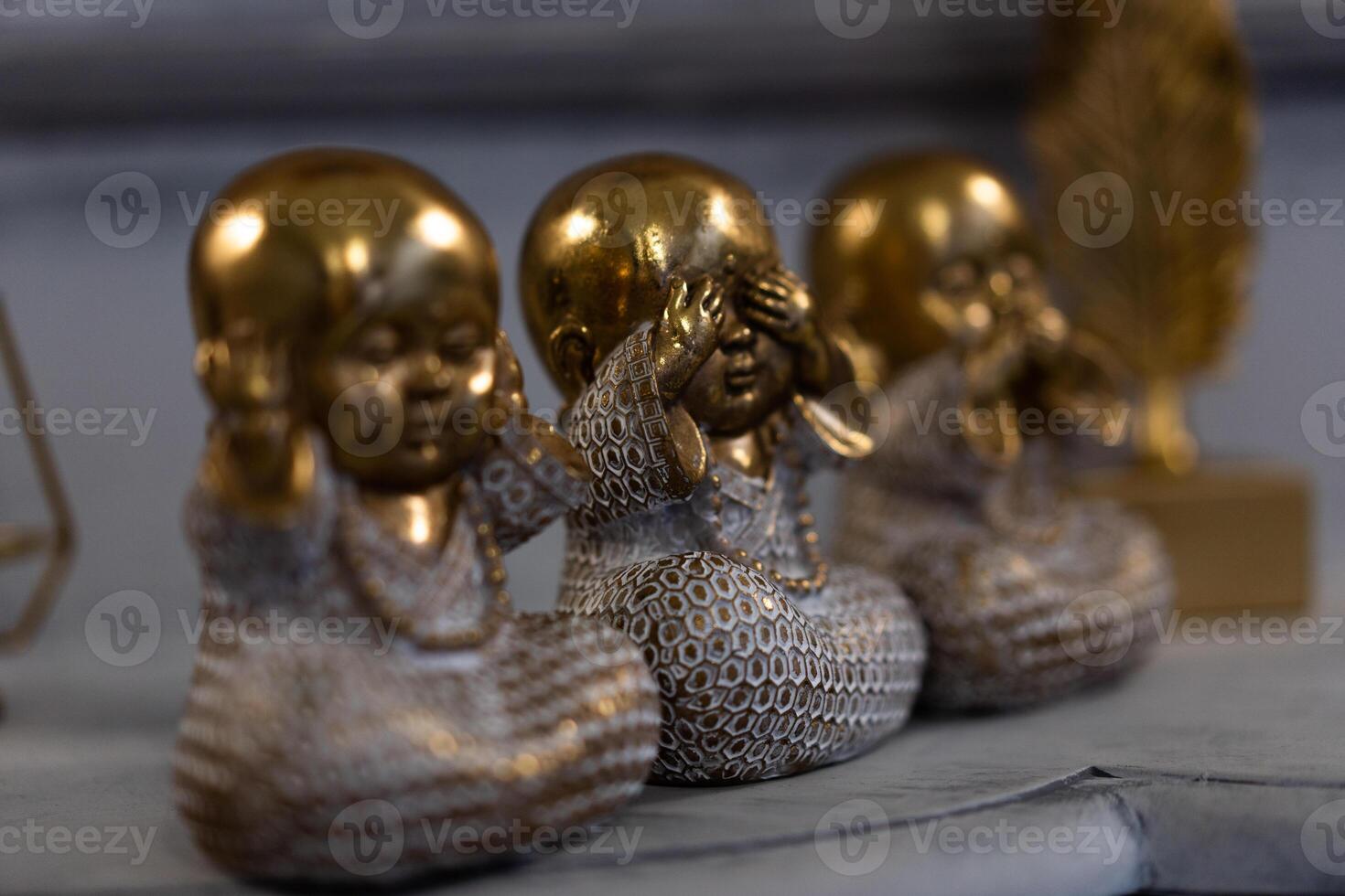 Three Wise little Buddha figurine in a row, Hear no evil, See no evil, Speak no evil, photo