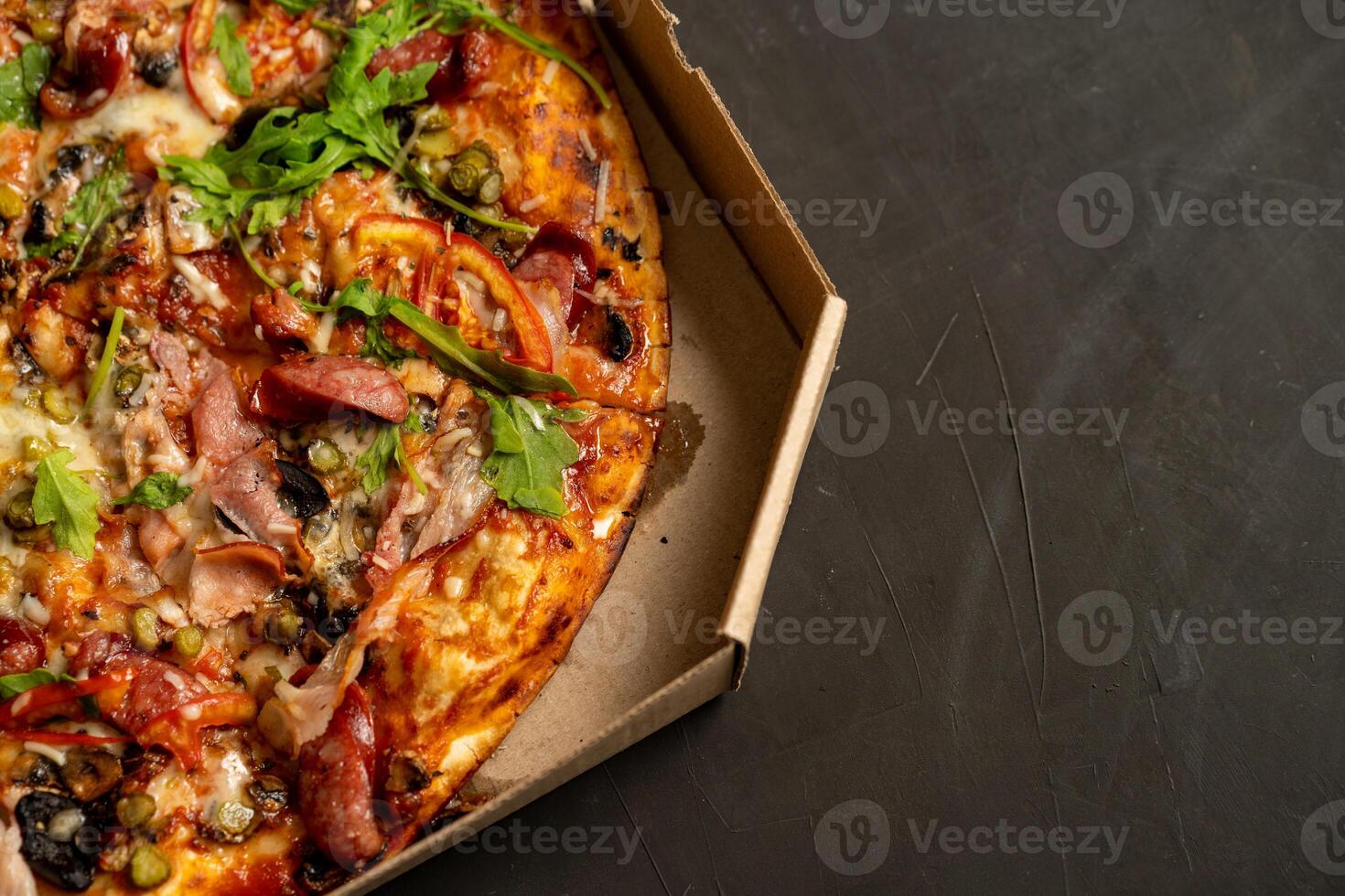 Appetizing pizza with smoked sausages bacon meat tomato cheese arugula photo