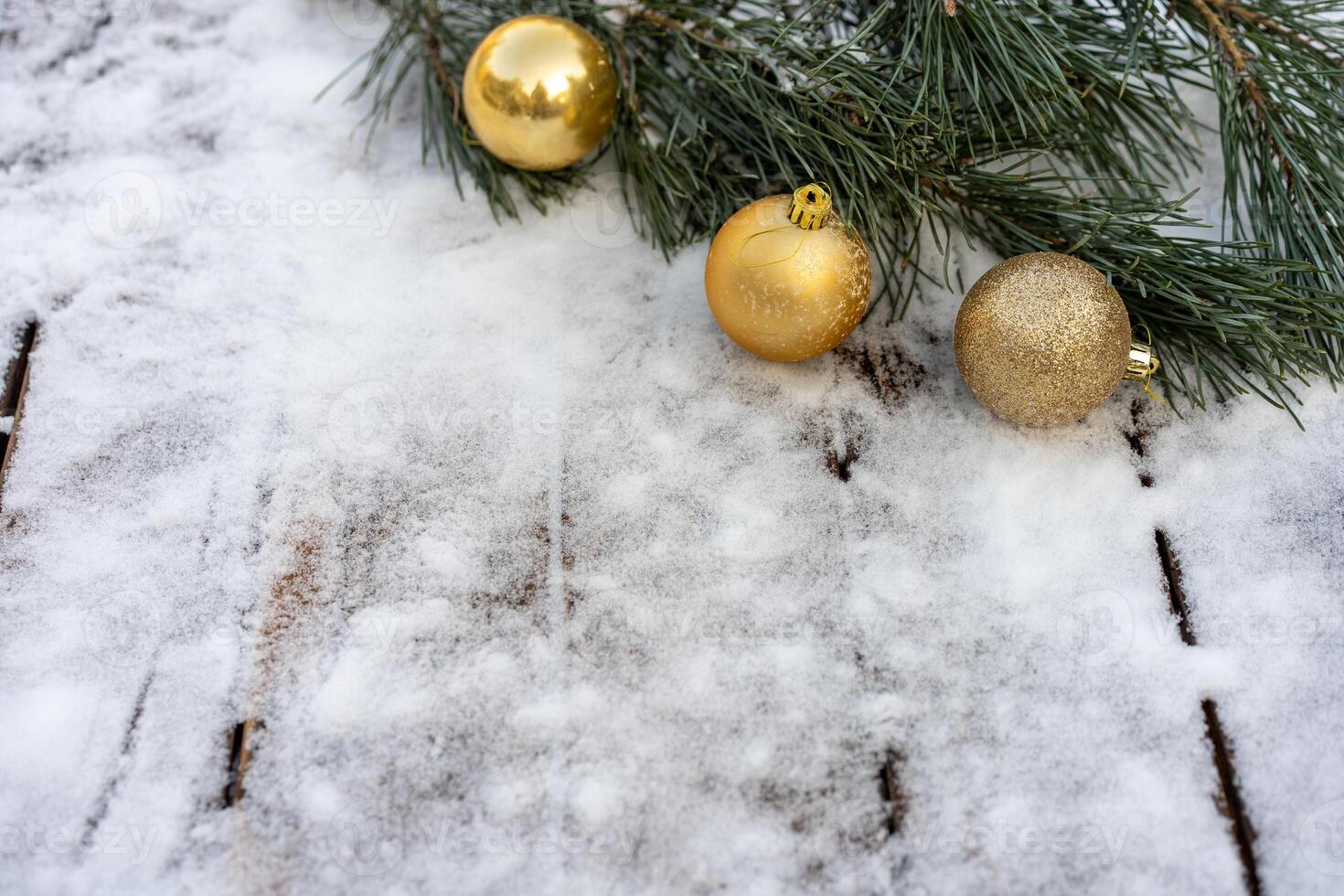 Winter background. Empty wooden plank with snowy border with pine branch and christmas ball decoration photo