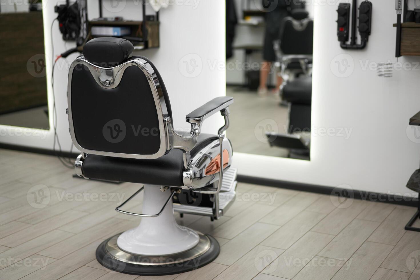 Classic vintage barber chair stands opposite mirror stylish white barber shop interior. photo