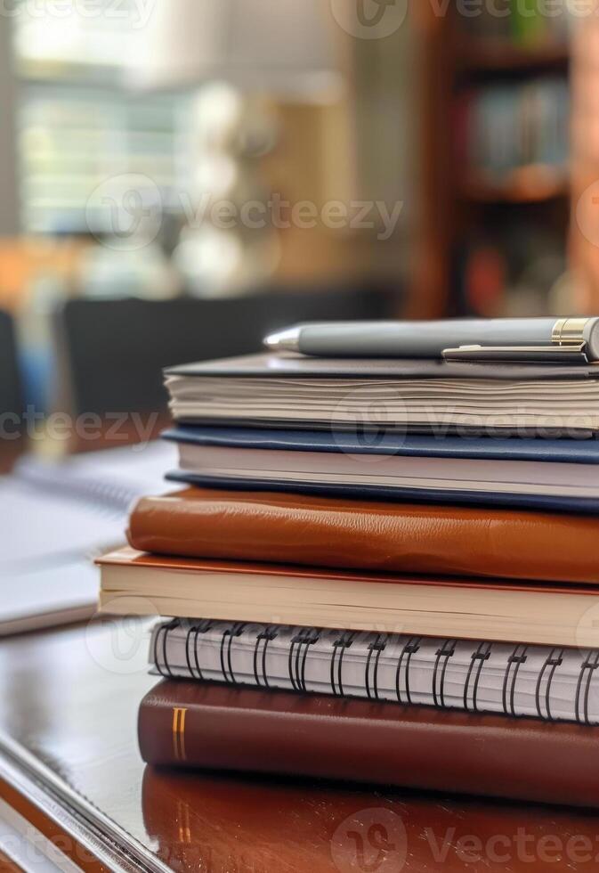 AI generated Stack of books. A stack of spiral notebooks and hardcover books with a pen on top photo