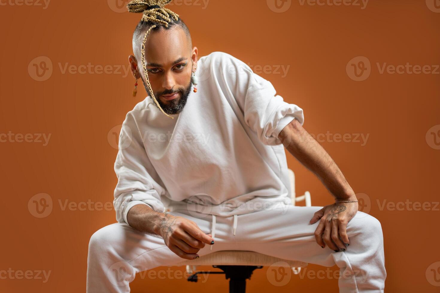 Black latin gay man isolated on orange background photo