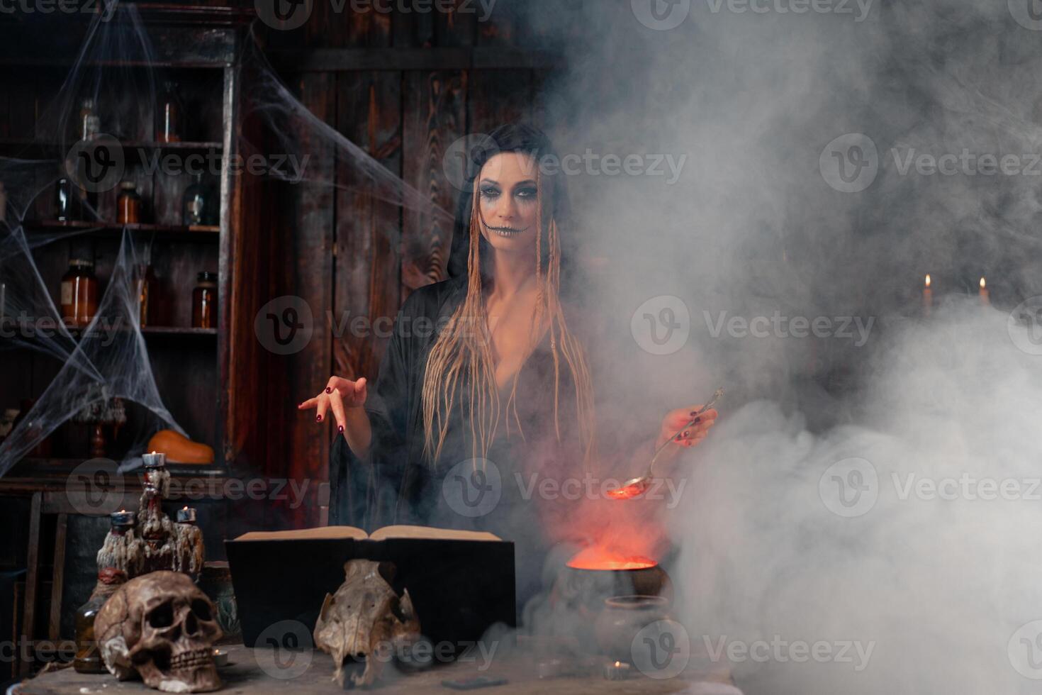 Halloween, witch use magic book and cauldron prepare poison or love potion photo