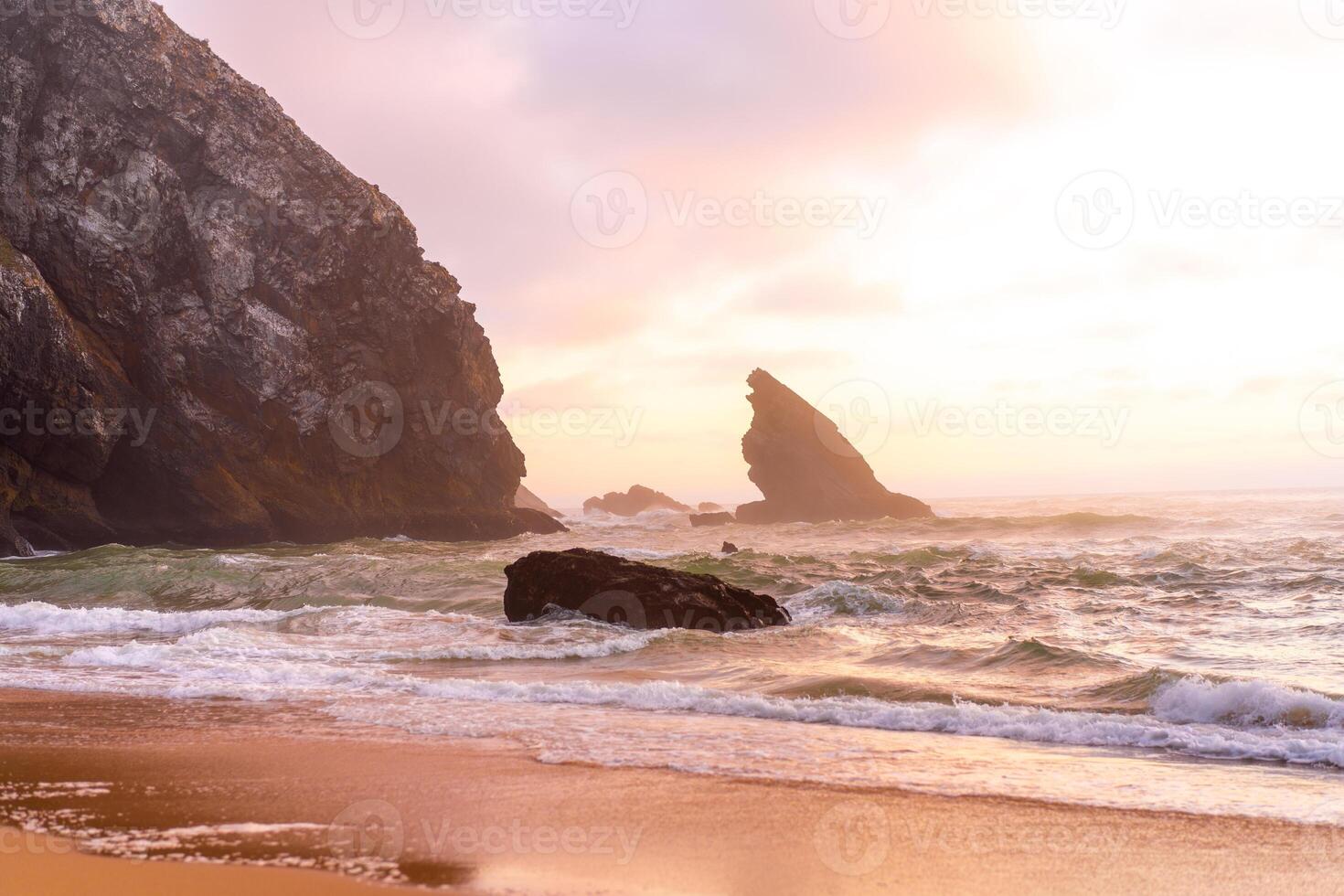 Ocean wild beach stormy weather. Praia da Adraga sandy beach with picturesque landscape background, Sintra Cascais, Portugal photo