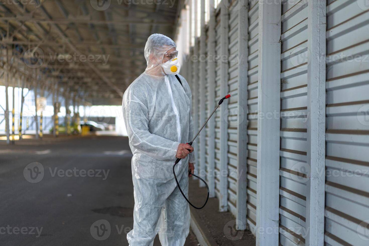 Worker wearing protective suit disinfection gear disinfect surface public place photo