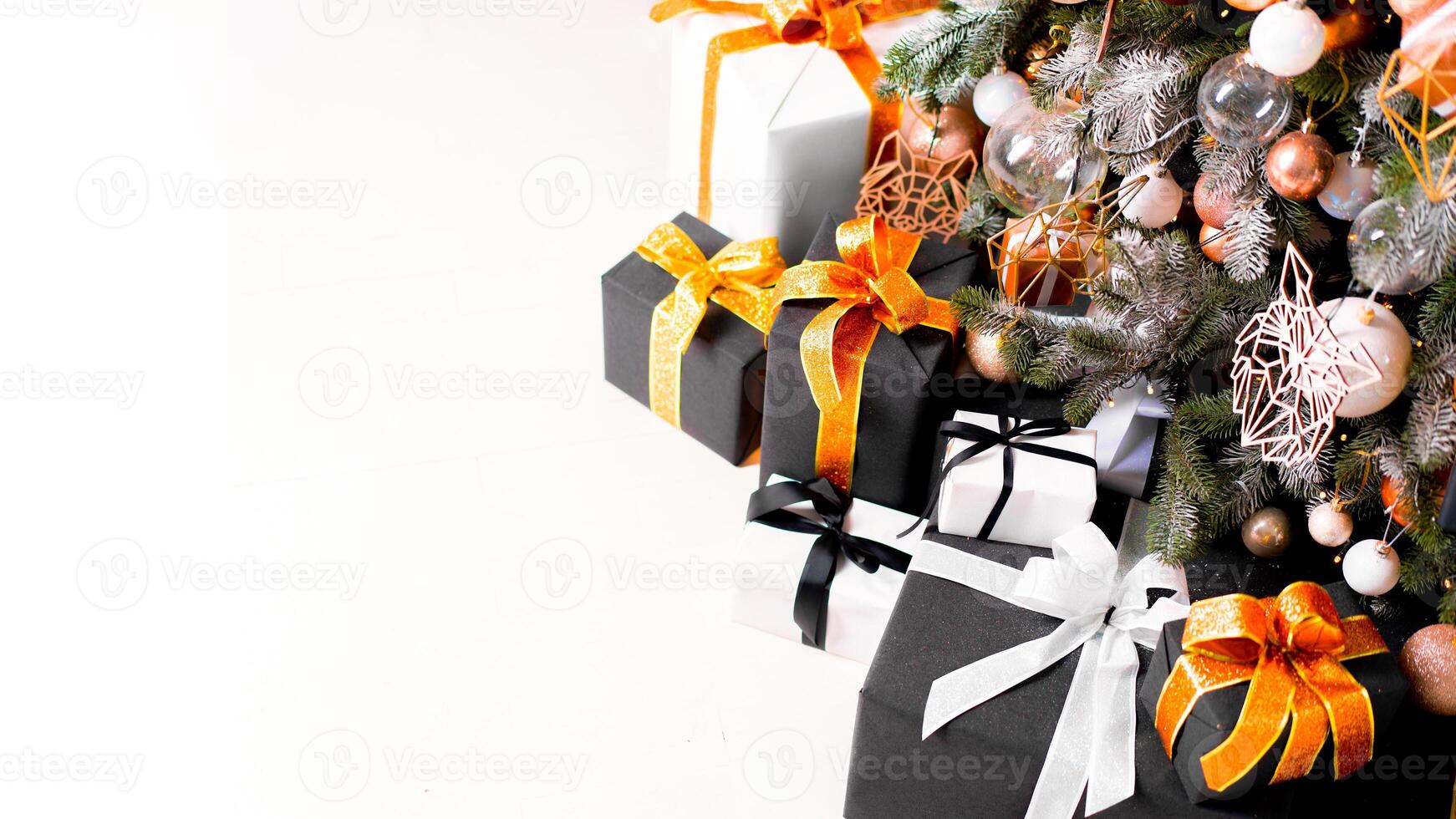 Christmas present box black, orange and white color on white floor with copy space photo
