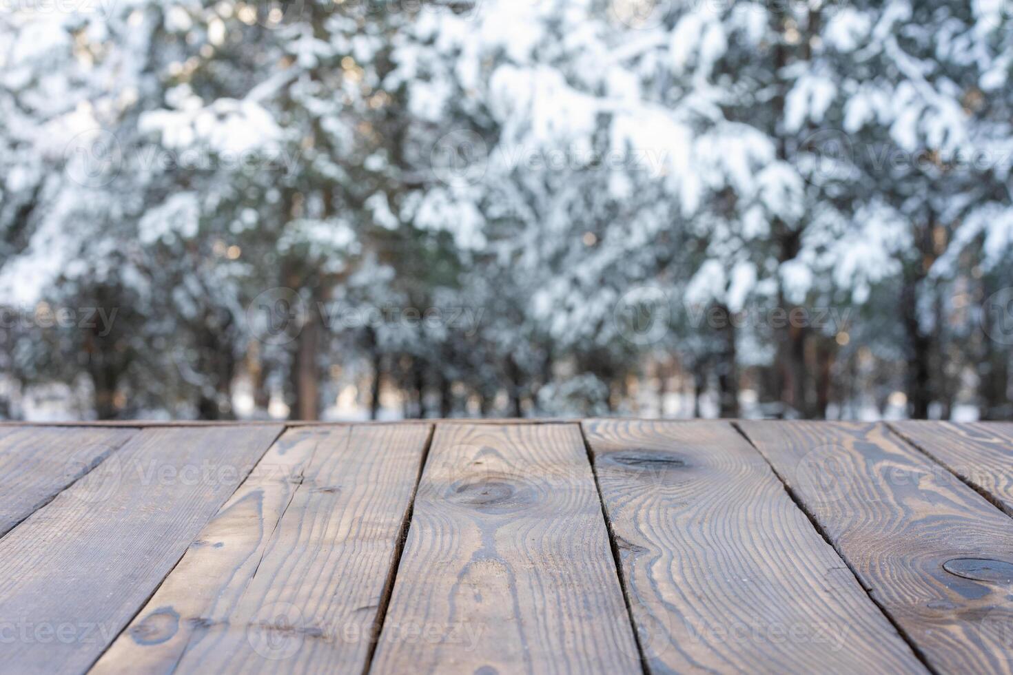 Beautiful winter scene. blurred background of snowy christmas nature background, Wood table top on shiny bokeh. For product display Christmas time mock up photo