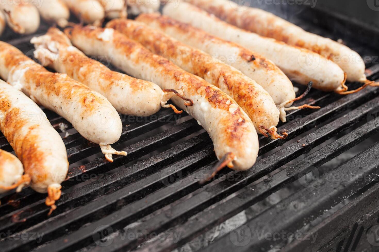 BBQ with fiery sausages on the grill photo