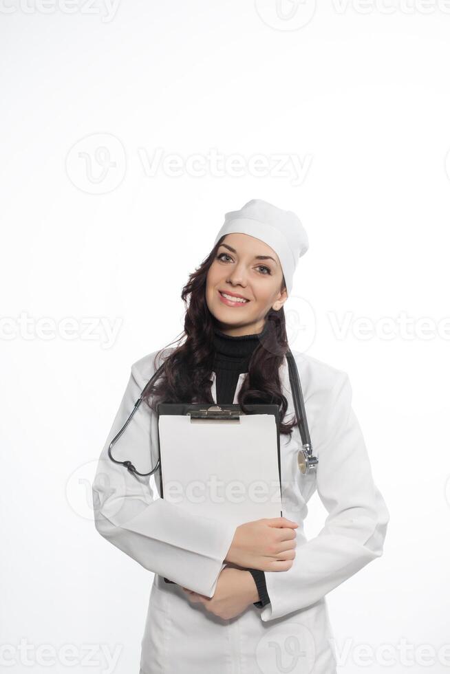 a woman in a white coat holding clipboard photo