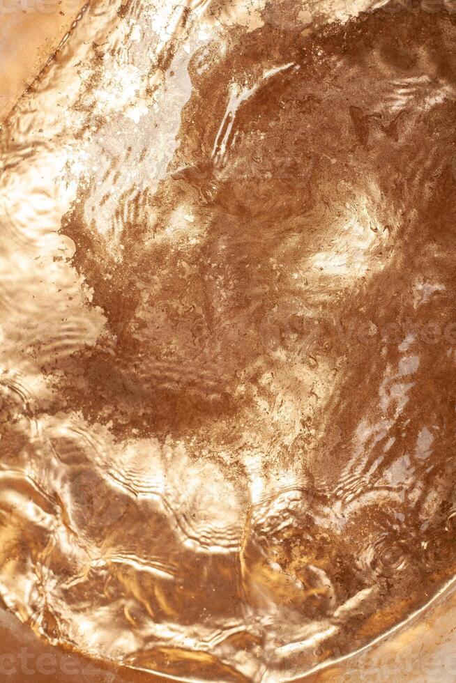 Gold chemical dirty colored water background close up photo