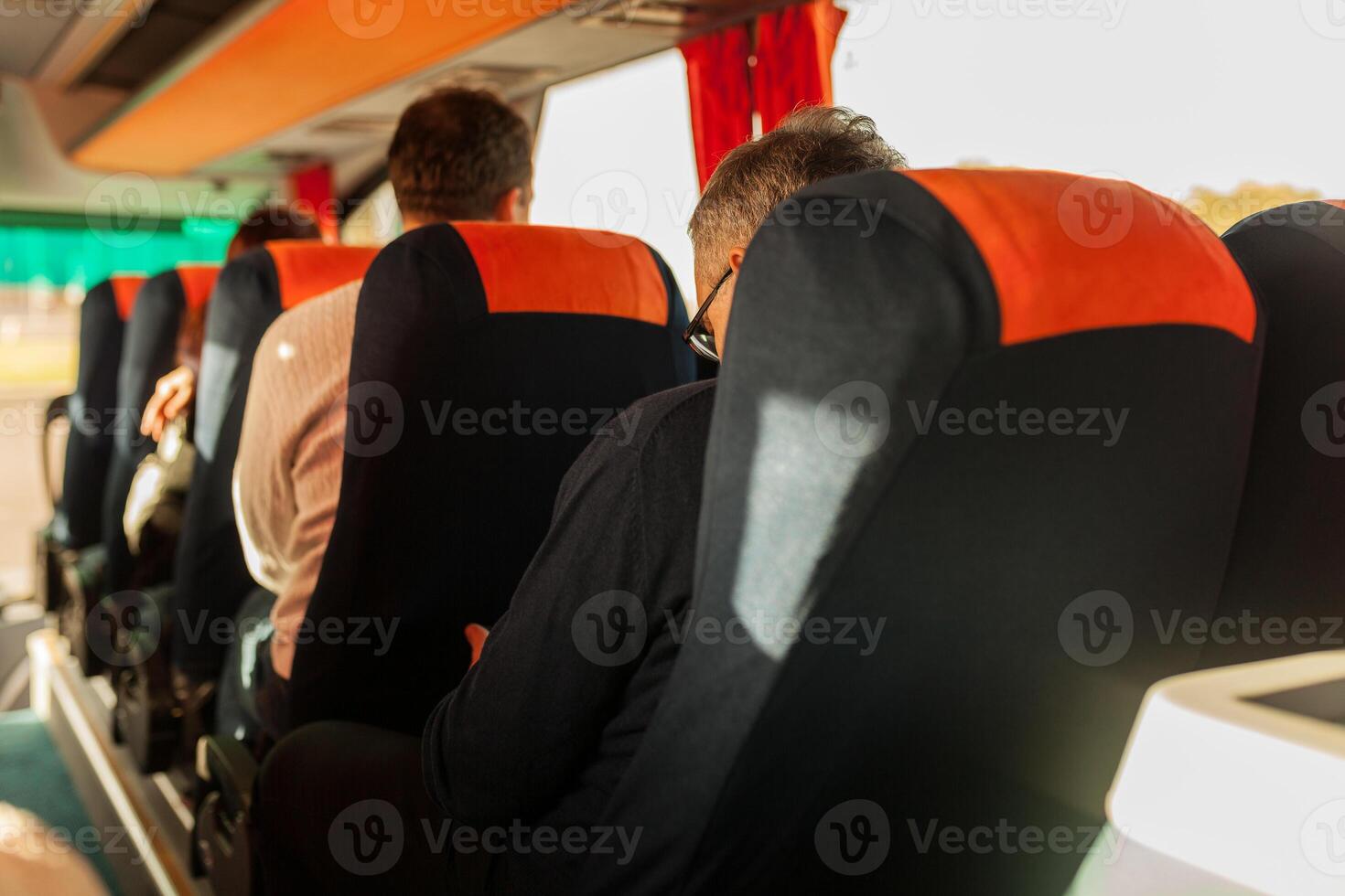 interior of bus with passengers rear view photo