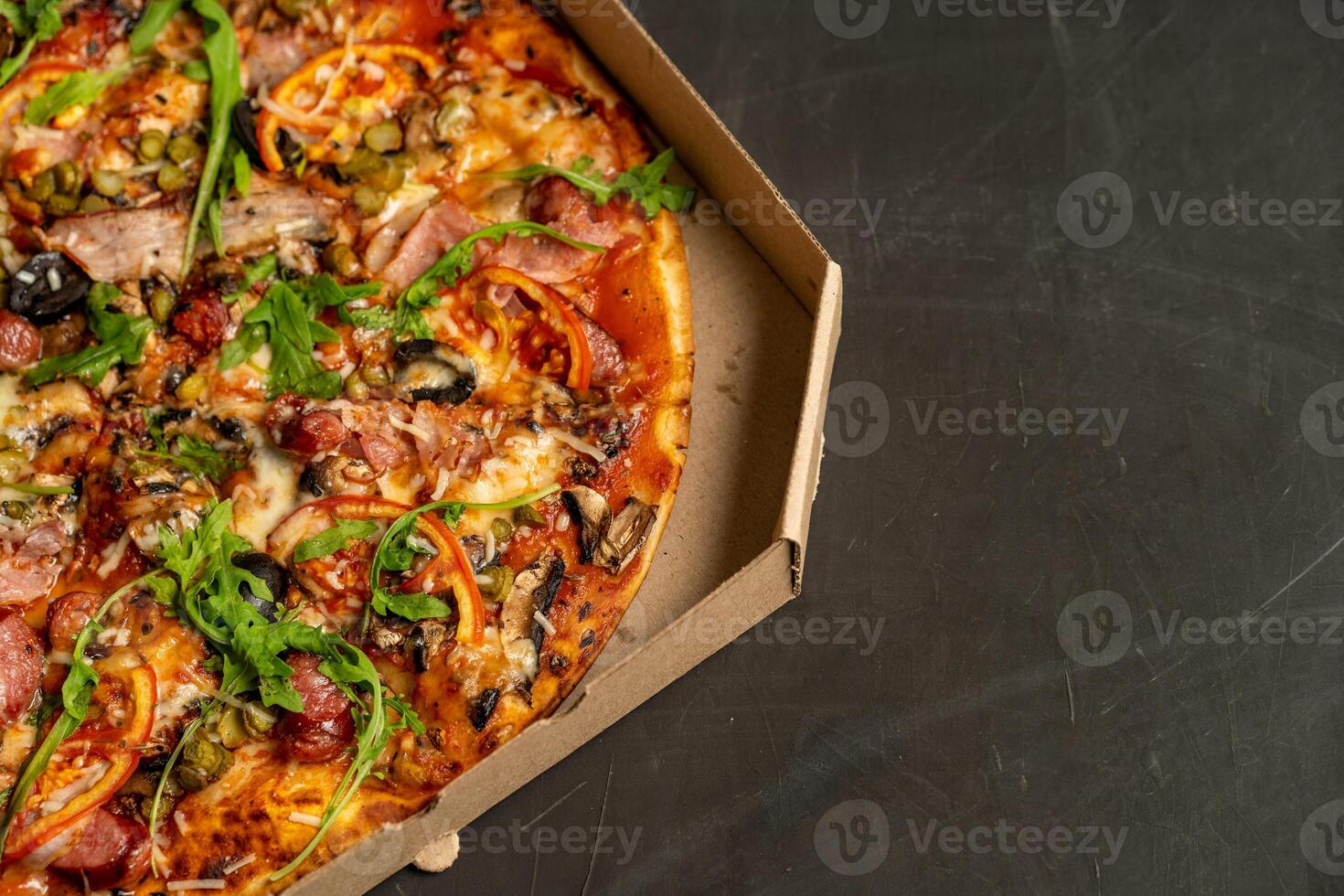 Appetizing pizza with smoked sausages bacon meat tomato cheese arugula photo