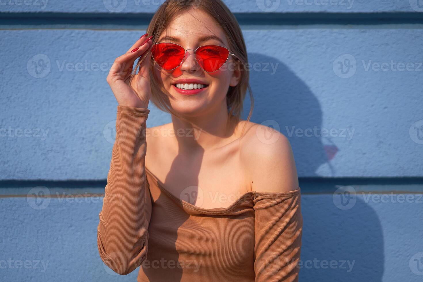 Beautiful young Caucasian woman walks streets of the city warm summer sunny day . photo