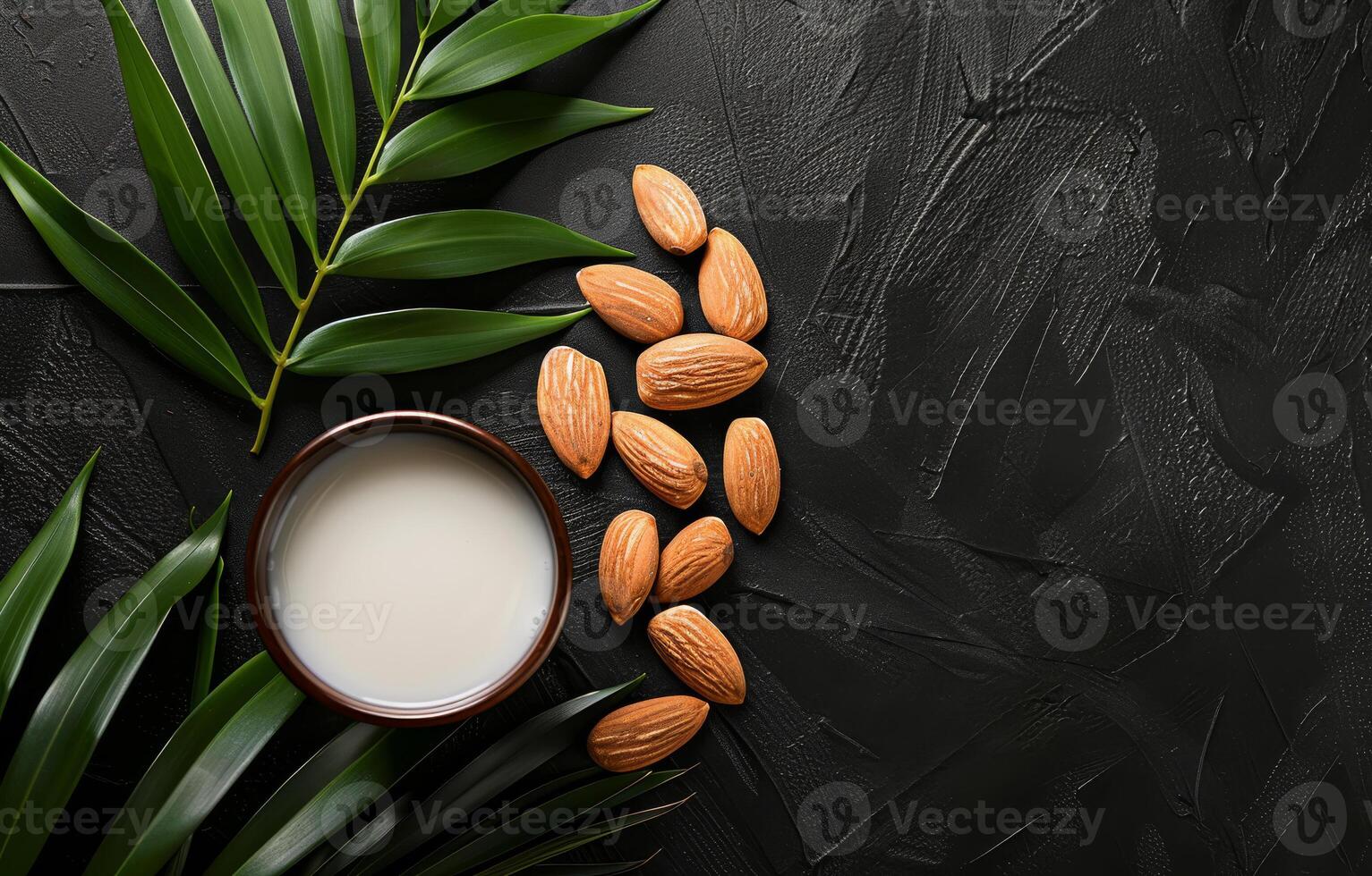 AI generated Almond milk in bowl and almonds with green leaves on black stone table photo