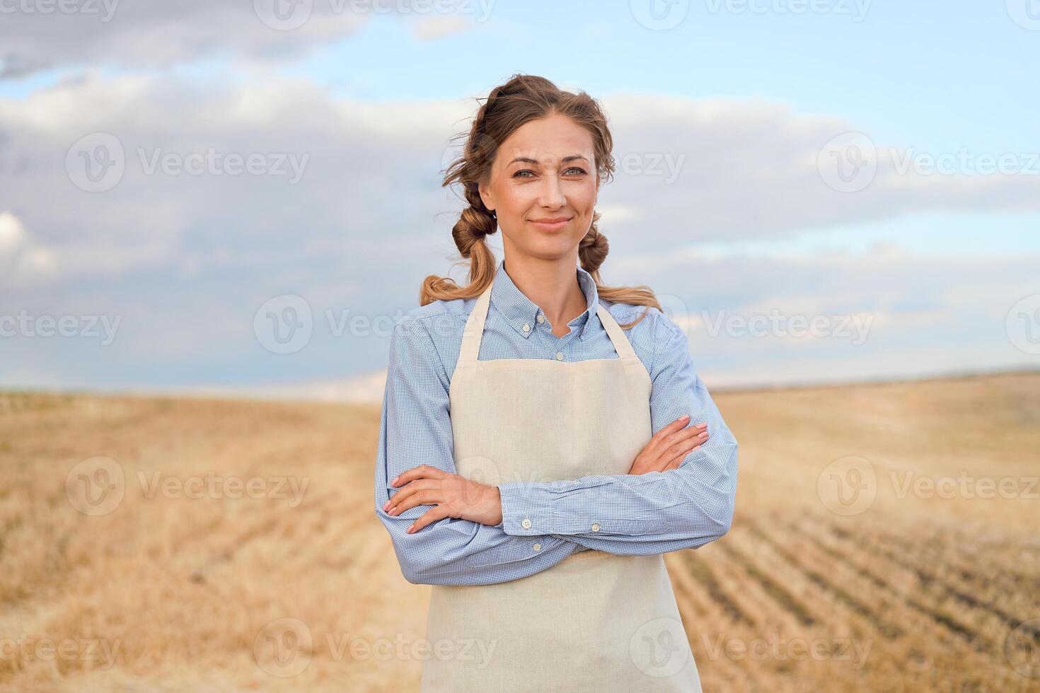 Woman farmer apron standing farmland smiling Female agronomist specialist farming agribusiness Happy positive caucasian worker agricultural field photo