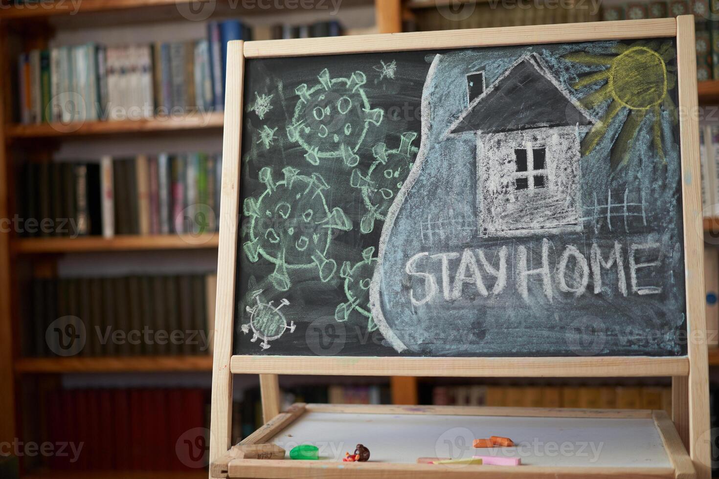 Hashtag stay at home. Outbreak Warning. written white chalk on blackboard in connection with epidemic of coronavirus worldwide. photo