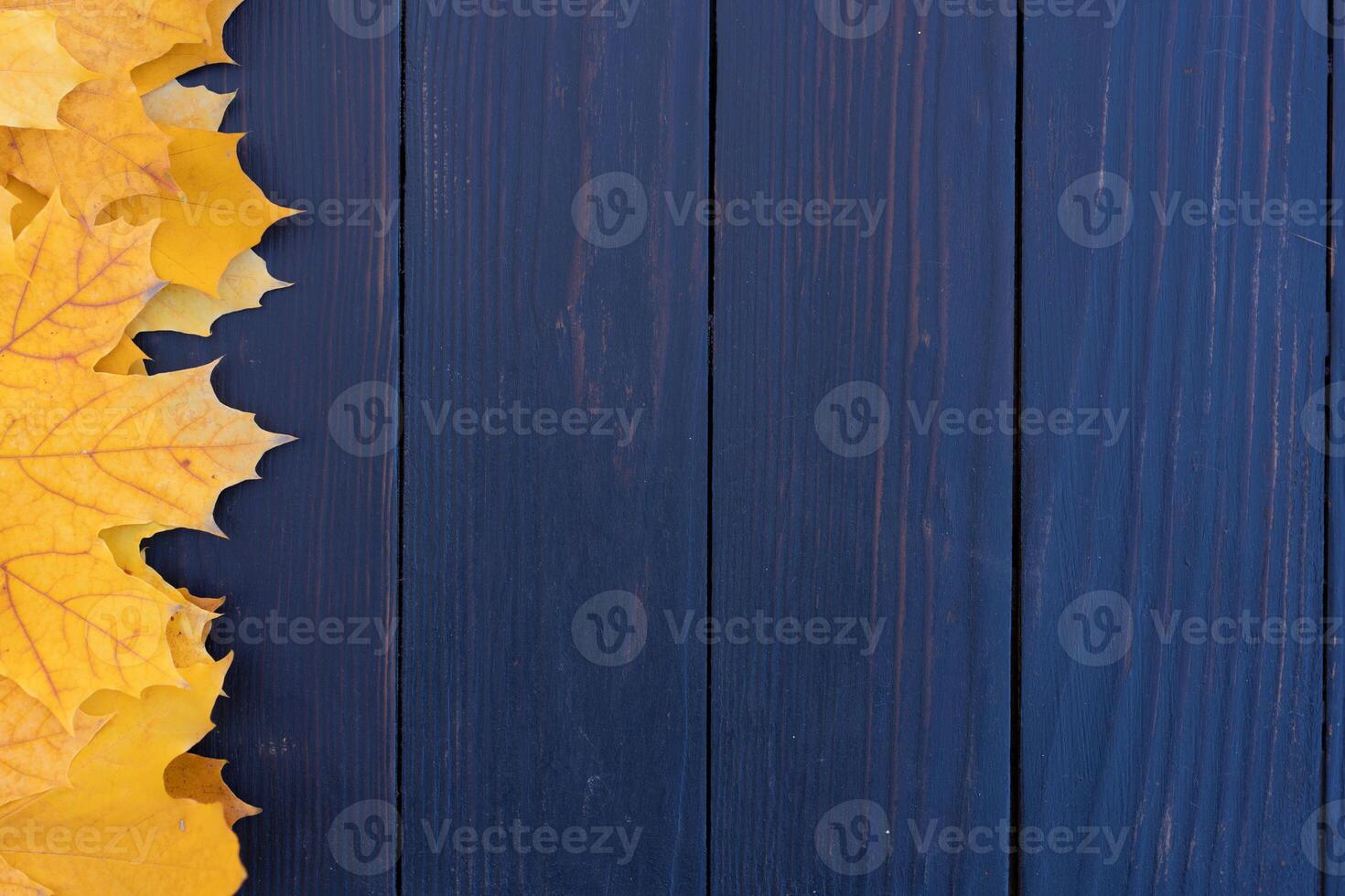 Autumn leaves frame on wooden background top view Fall Border yellow and Orange Leaves vintage wood table Copy space for text. photo