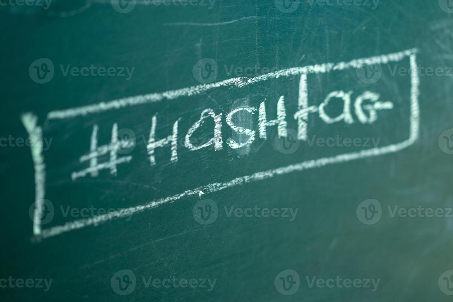 Closeup on hashtag symbol white chalk on a blackboard copy space background photo