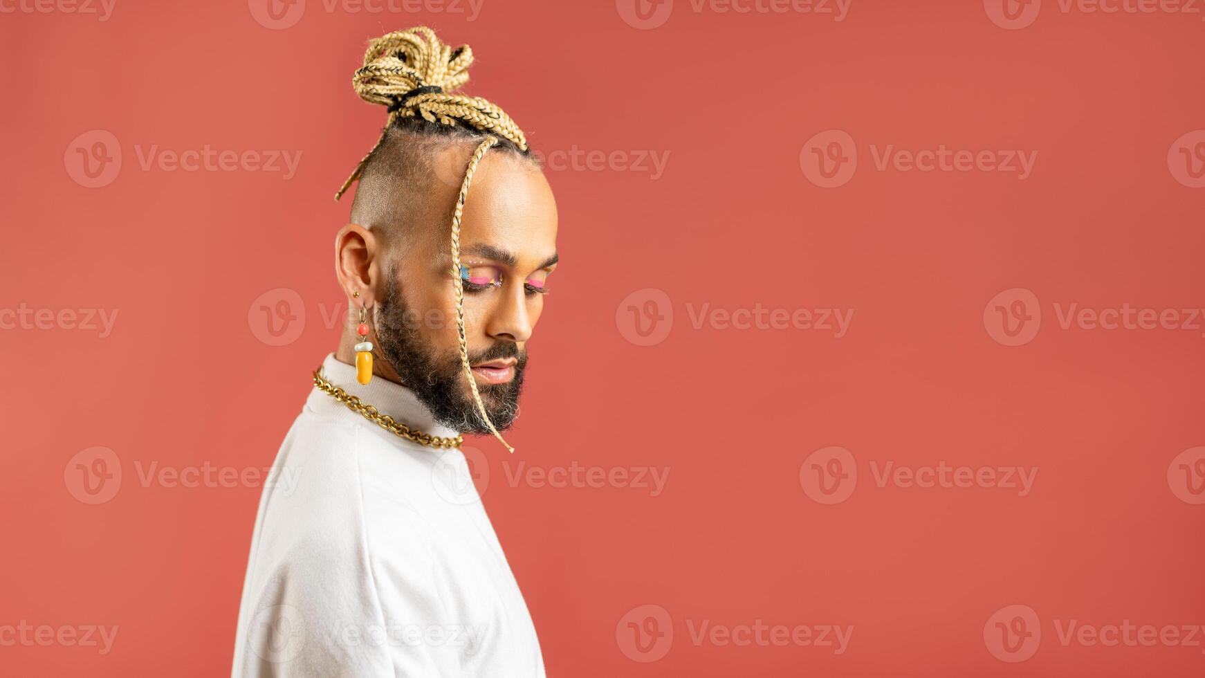 Black latin gay man isolated on pink background photo