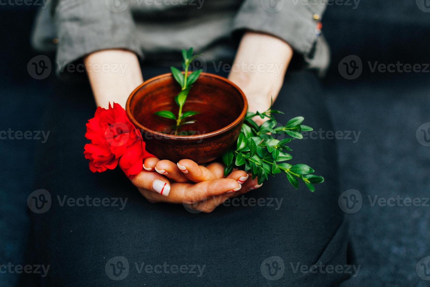 Woman offers hot tea in a vintage ceramic cup. photo