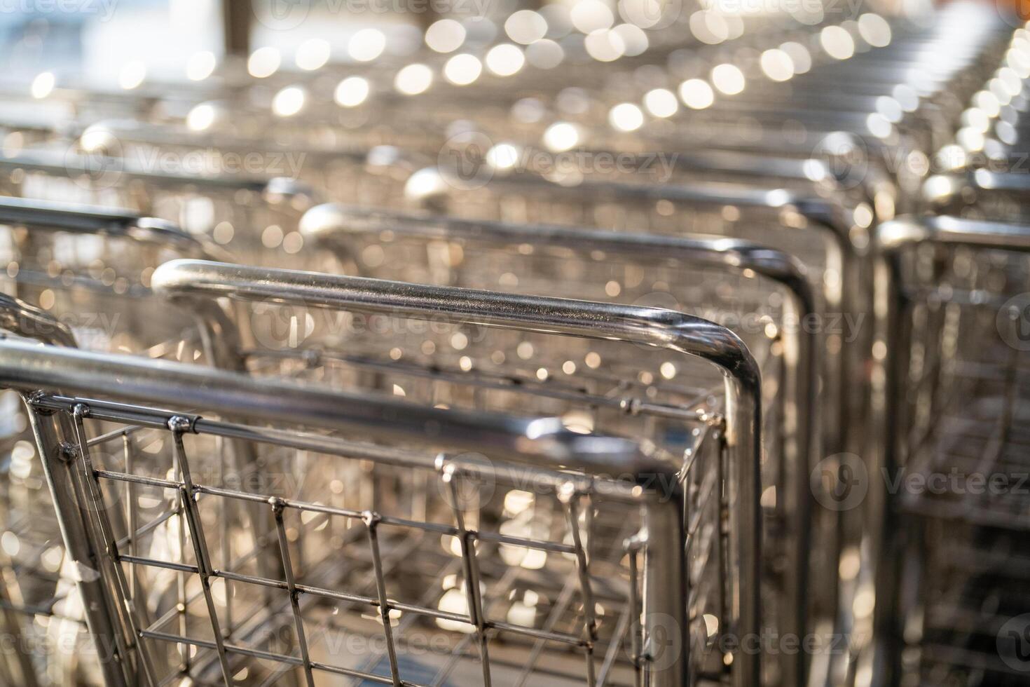 Empty airport baggage trolleys parked at the airport. photo