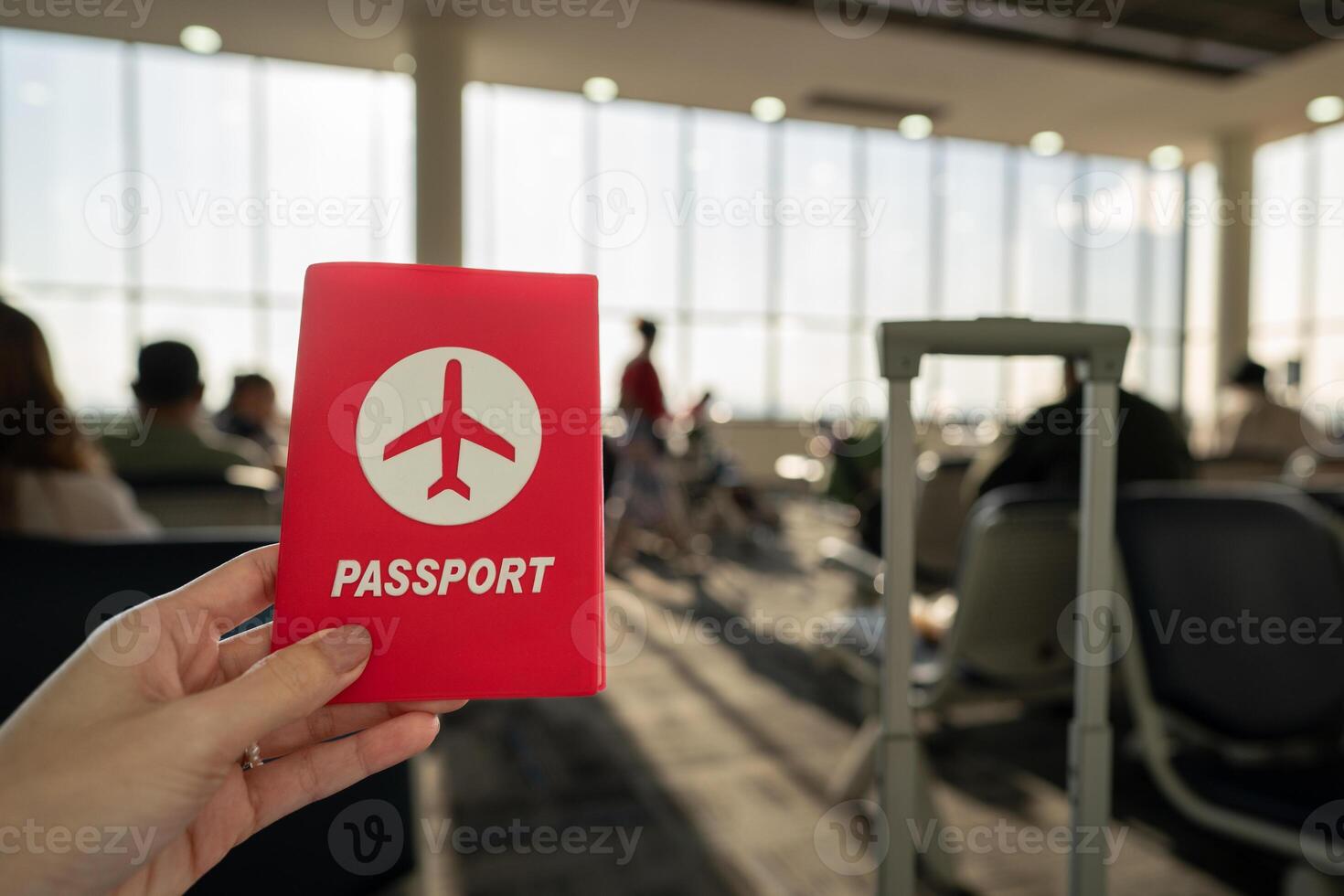 Hand holding passport at the airport at boarding gate. photo