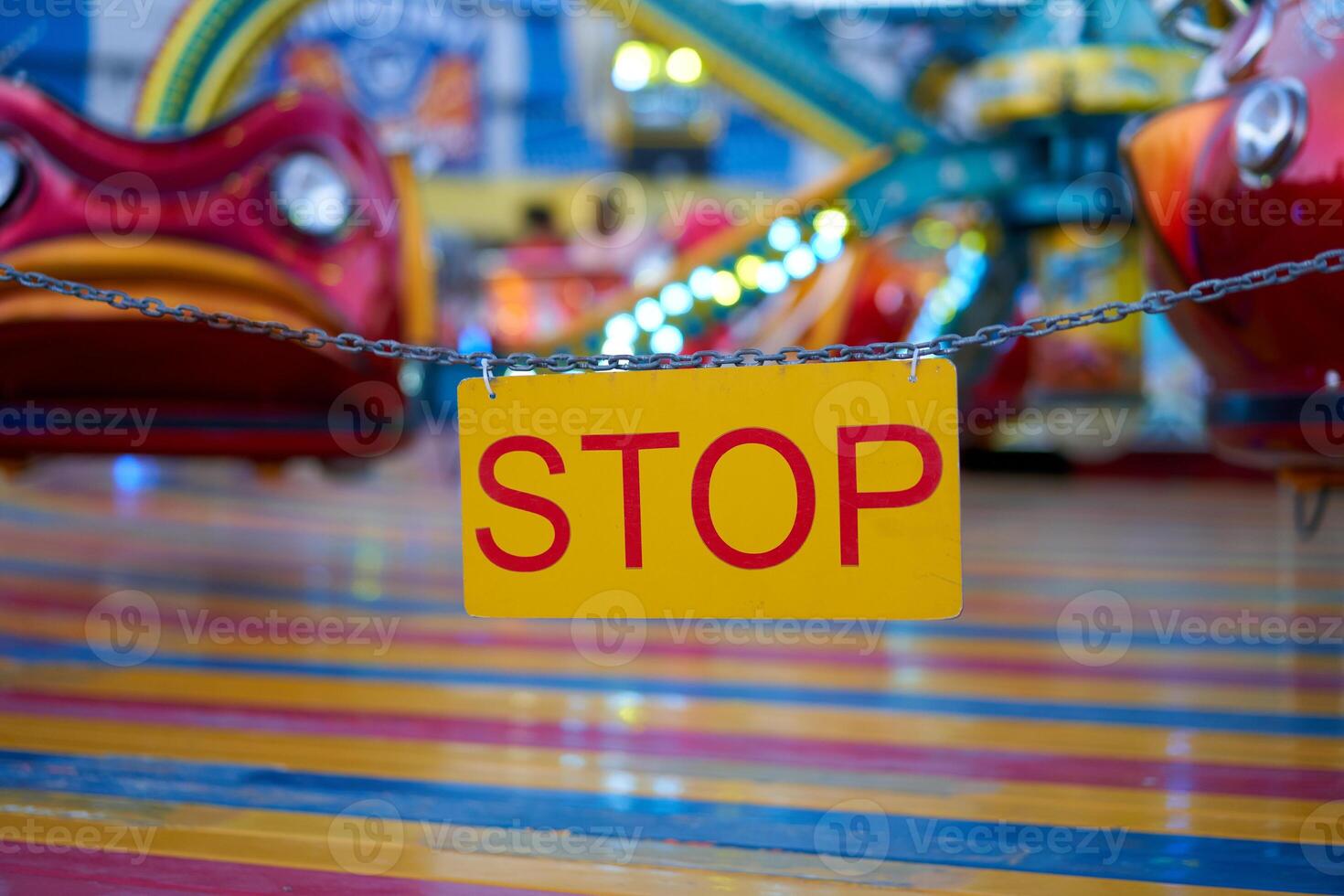 Stop sign with carnival festival blurred Carousel background photo