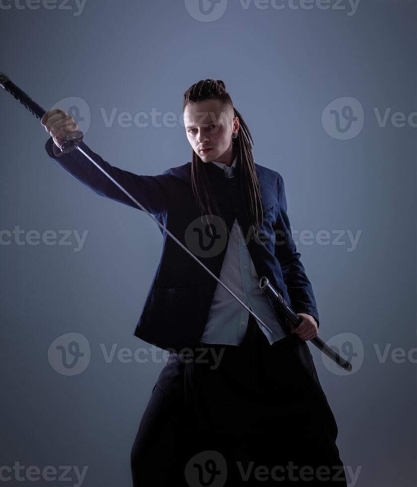Young man holding a samurai sword. Glamour photo. photo