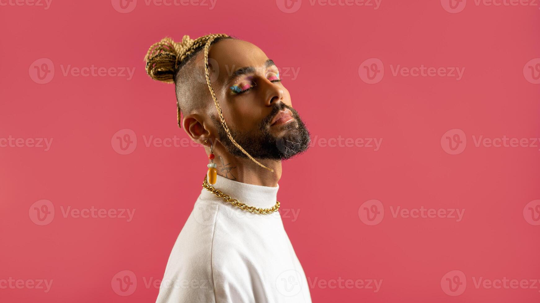 Black latin gay man isolated on pink background photo