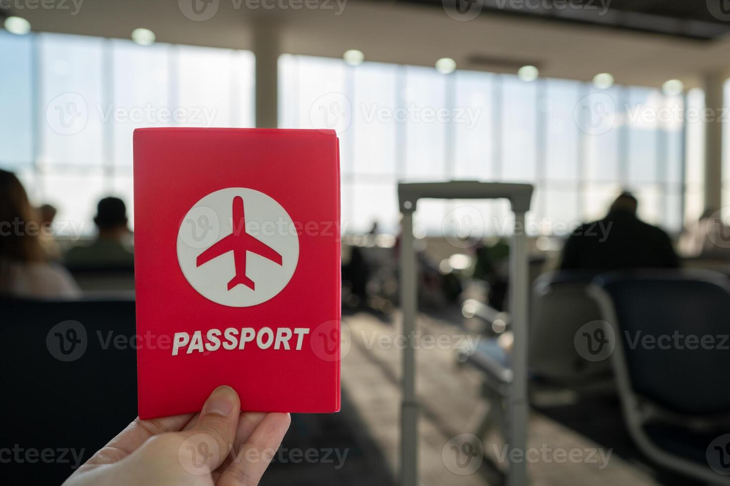 Hand holding passport at the airport at boarding gate. photo