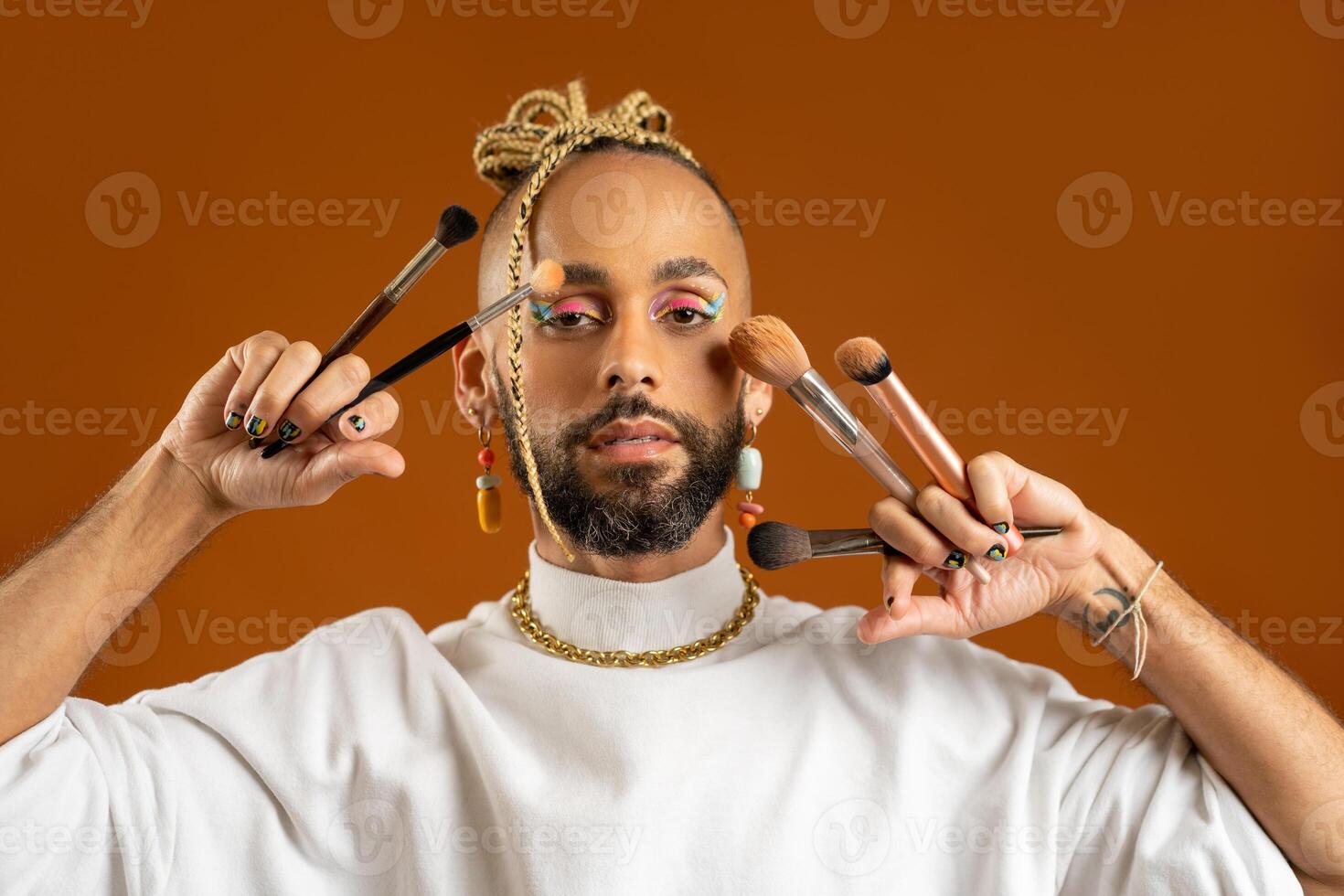 African american gay applying make up isolated on brown background photo