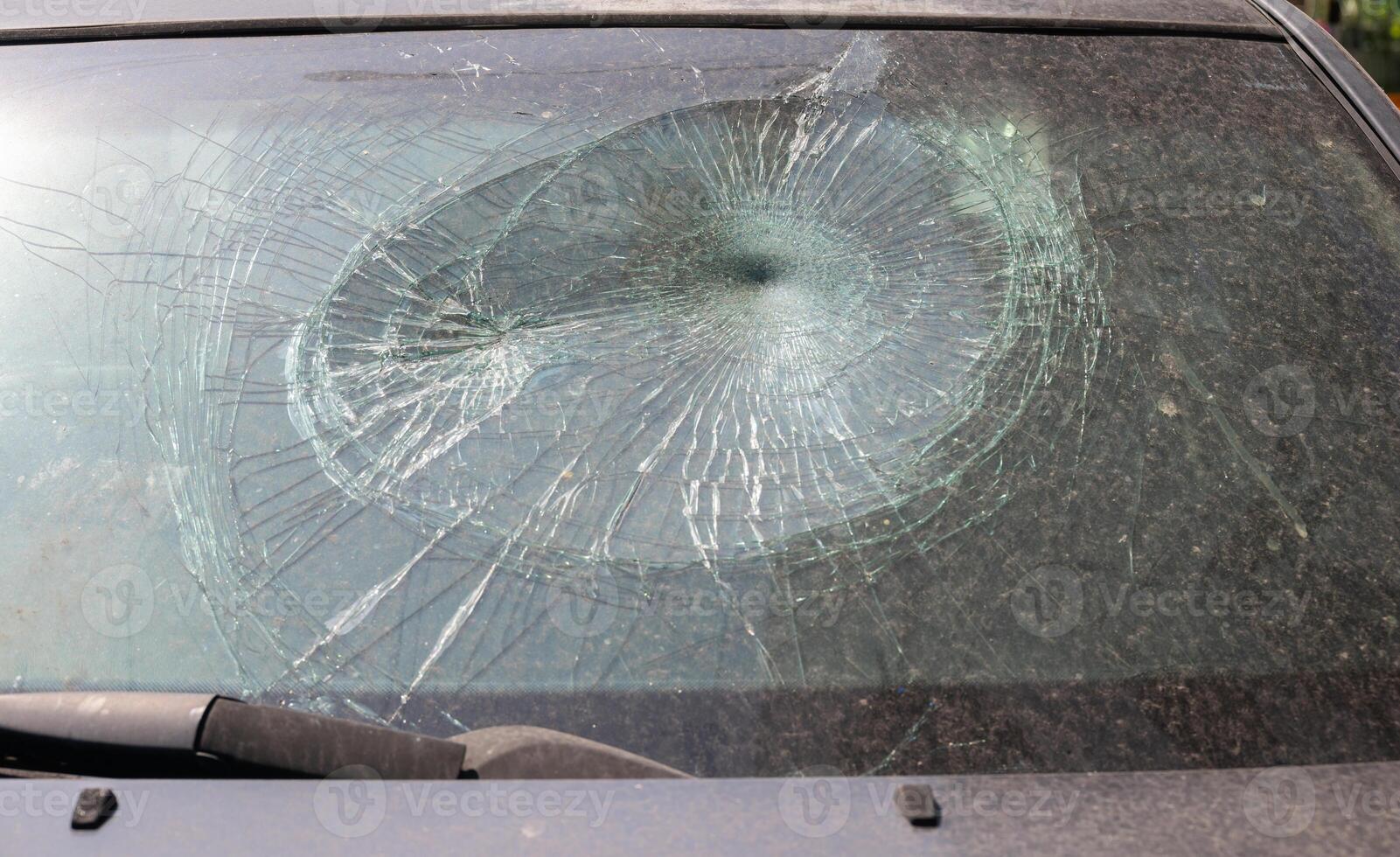 Broken automobile windshield of accident crashed car photo
