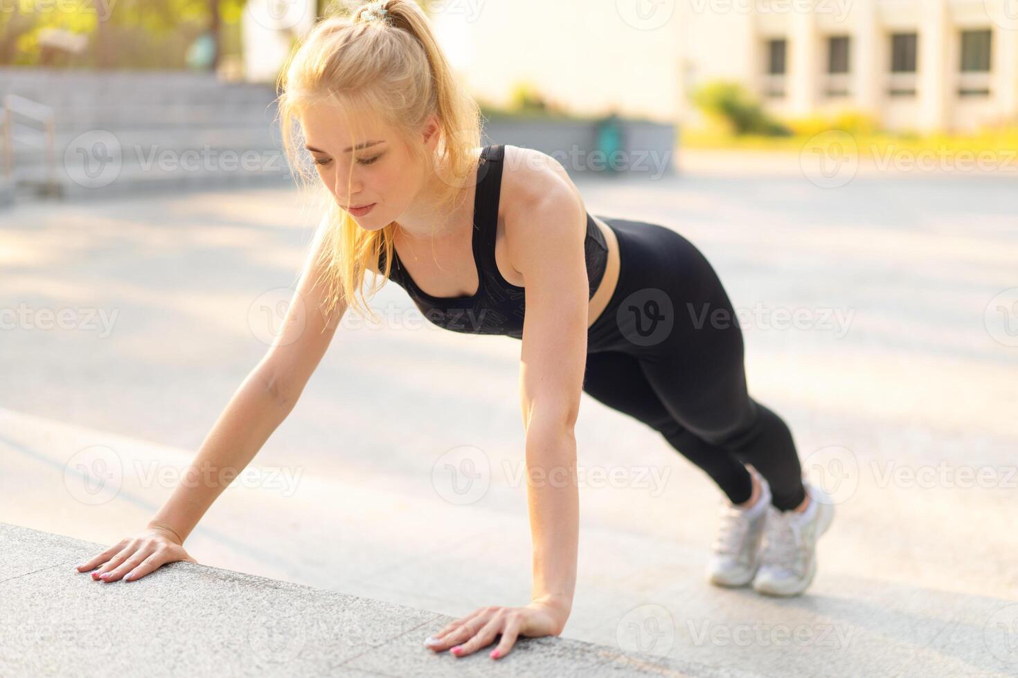 Sport and Fitness Fit Young Adult Woman Doing Plank Exercise Outdoor Urban Environment. Sunlight Summer Park photo