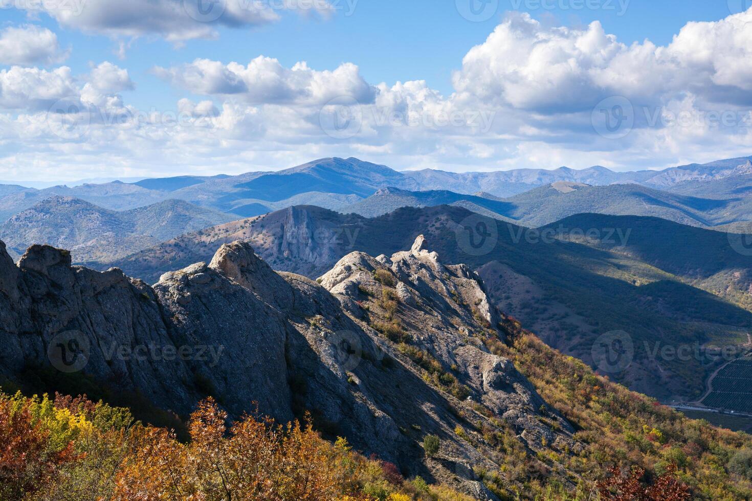 landscape with yellow and green trees against mountains and the beautiful sky photo