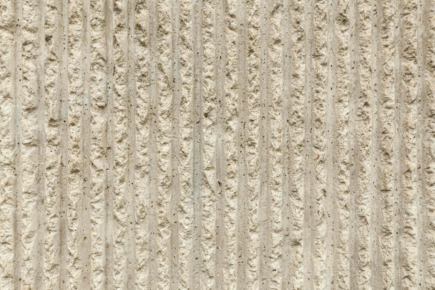 Surface of the wall with a decorative white plaster. Textured concrete wall with vertical lines and stripes as a texture or background. Repair, design concept. photo